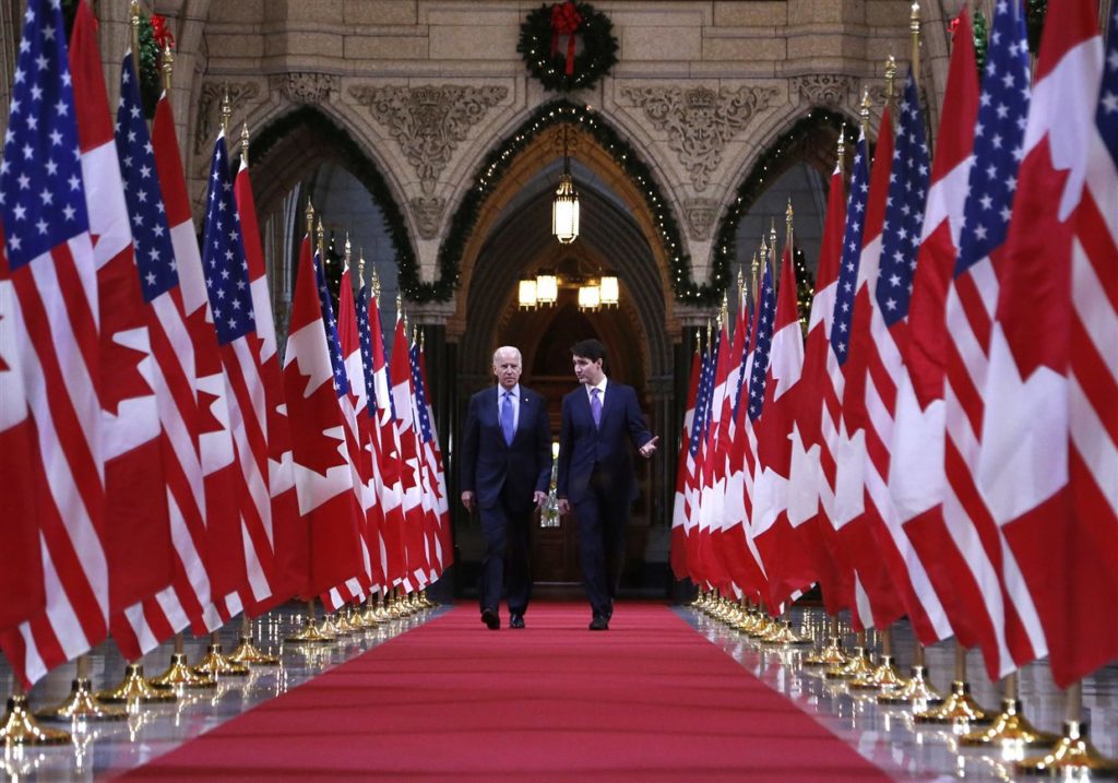 Prime Minister Justin Trudeau walking down the Hall of Honour on Parliament Hill with Joe Biden. beside Joe Biden