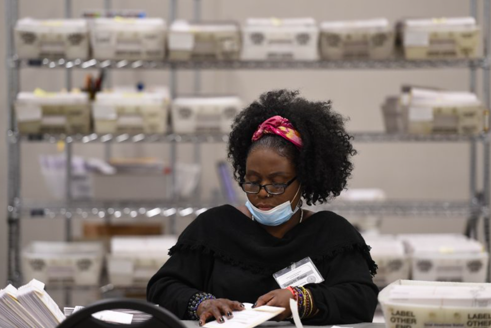 Cobb County Election officials count ballots. Monday, Nov. 16, 2020, in Marietta, Ga. (AP Photo/Mike Stewart)