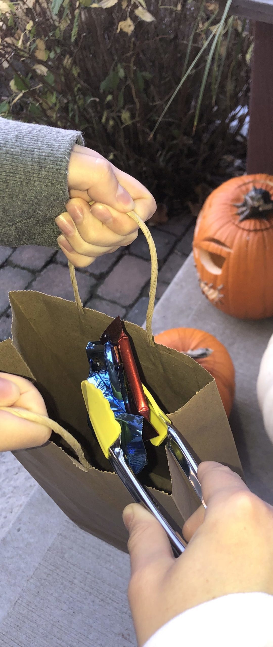 A safe form of handing out candy by using tongs.