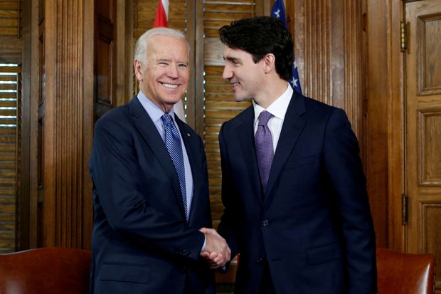 Prime Minister Justin Trudeau shakes hands with Joe Biden on Parliament Hill in Ottawa on December 9, 2016.