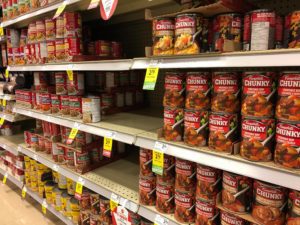 A store's soup shelf is partially sold-out