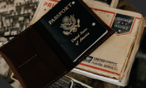 A US passport sitting on top of a postal service envelope.