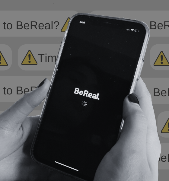 Close up of someone using the BeReal app with BeReal notifications in the background.