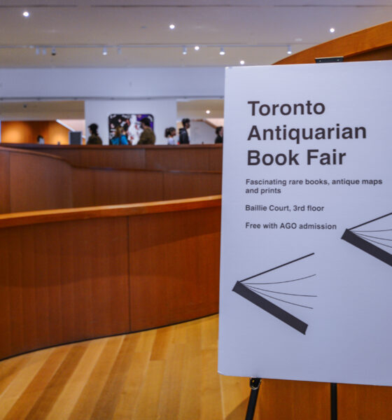 A sign in the lobby of the Art Gallery of Ontario directs attendees to the Toronto Antiquarian Book Fair.